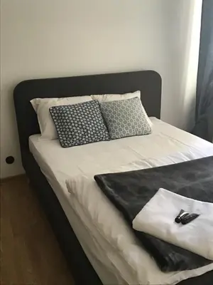 a bed with two black and white pillows on it at Apartment in Center in Kraków