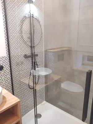 a shower with a glass door in a bathroom at Apartment in Center in Kraków