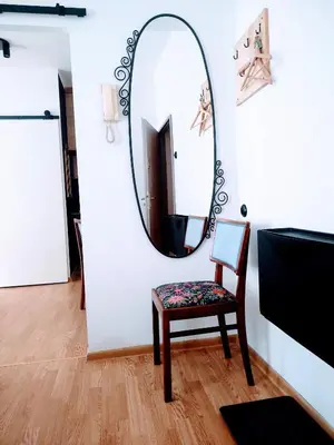 a chair and a mirror in a room at Apartment in Center in Kraków