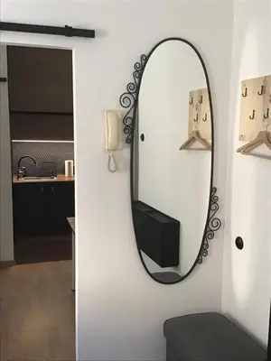 a mirror on a wall next to a bathroom at Apartment in Center in Kraków