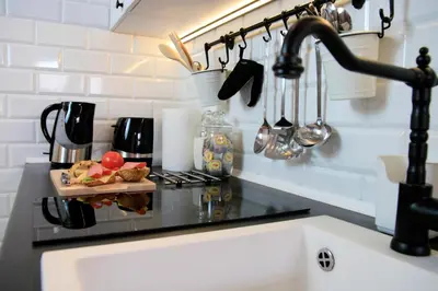 a kitchen counter top with a sink and a sink at Designer Apt in the heart of Kraków 4th floor no lift in Kraków