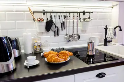 a kitchen counter with a plate of croissants and a plate of food at Designer Apt in the heart of Kraków 4th floor no lift in Kraków