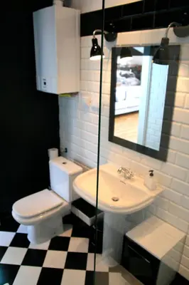 a bathroom with a toilet and a sink and a mirror at Designer Apt in the heart of Kraków 4th floor no lift in Kraków