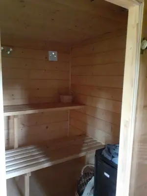 a wooden sauna with a bench in it at Agroturystyka Jagodowa Róża - Maria Farganus in Mszana Dolna