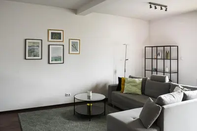 a living room with a couch and a table at Apartament Myślenice in Myślenice