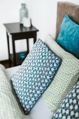 a couch with two pillows on it with a table at Apartament Myślenice in Myślenice