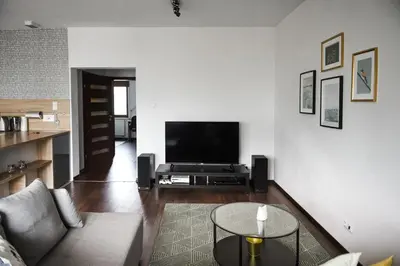 a living room with a couch and a flat screen tv at Apartament Myślenice in Myślenice