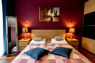 a bedroom with a large bed with two pillows at Verona Apartment 129 - 70m2, Terrace, Garage in Kraków