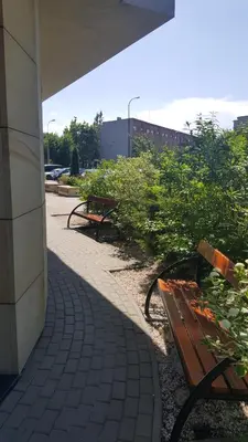 two benches sitting on a sidewalk next to a building at Verona Apartment 129 - 70m2, Terrace, Garage in Kraków