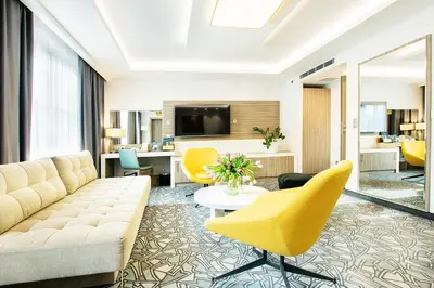 a living room with a couch and chairs at Golden Tulip Krakow Kazimierz in Kraków