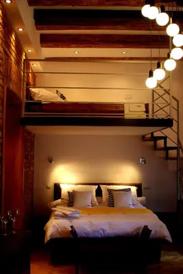 a bedroom with a bed and a loft bed at Cracowapart Loft Gertruda in Kraków