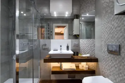 a bathroom with a sink and a shower at Cracowapart Loft Gertruda in Kraków