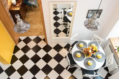 a dining room with a table with eggs on it at Cracowapart Loft Gertruda in Kraków