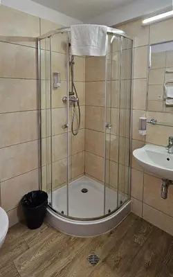 a shower with a glass door in a bathroom at Hotel Great Polonia Kraków Airport in Modlniczka