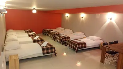 a room with a bunch of beds in it at Hostel Bazar in Kraków