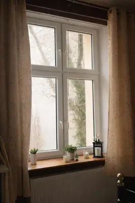 a brick wall with a white table and chairs at Elpida Apartment in Kraków