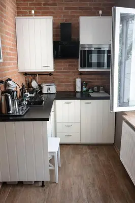 a hallway with a door and a wooden floor at Elpida Apartment in Kraków
