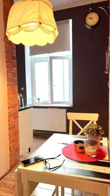 a window with potted plants on a wooden window sill at Elpida Apartment in Kraków
