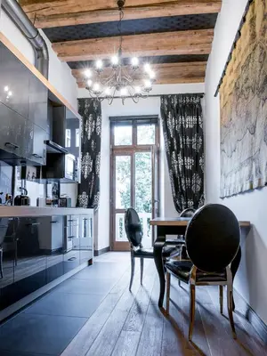 a kitchen with a dining room table and chairs at Leonardo 2 in Kraków