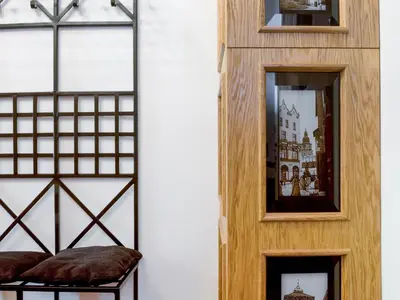 a room with a wooden door and two mirrors at Leonardo 2 in Kraków