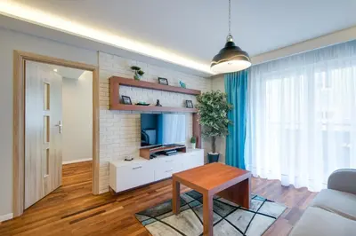 a living room with a brick wall at River Boulevards Apartment in Kraków