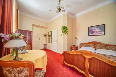 a bedroom with a bed and a table with a lamp at Pollera in Kraków