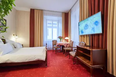 a hotel room with a bed and a table at Pollera in Kraków