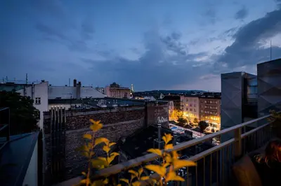 a view of a city at night from a balcony at Hotel Indigo Krakow - Old Town by IHG in Kraków