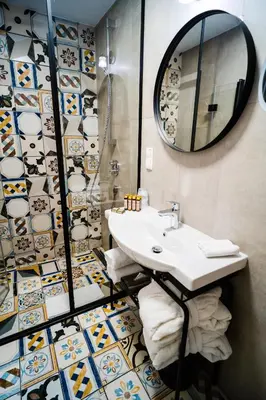 a bathroom with a sink and a mirror at Hotel Indigo Krakow - Old Town by IHG in Kraków