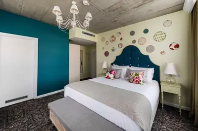 a bedroom with a large bed with a blue wall at Hotel Indigo Krakow - Old Town by IHG in Kraków