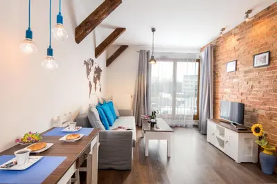 a bedroom with a bed with blue and white pillows at Passion4Cracow in Kraków