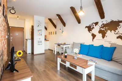a living room with a couch and a brick wall at Passion4Cracow in Kraków