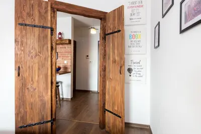 an open wooden door in a room with a table at Passion4Cracow in Kraków