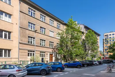 a row of cars parked in front of a building at Królewska Apartments in Kraków