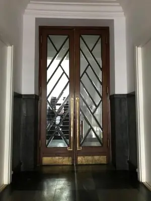 a wooden door with a window in a room at Królewska Apartments in Kraków