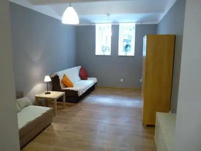 a living room with a couch and a table at Pokoje Gościnne Centrum in Kraków