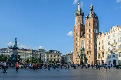 a group of people walking around a city with buildings at Pokoje Gościnne Centrum in Kraków