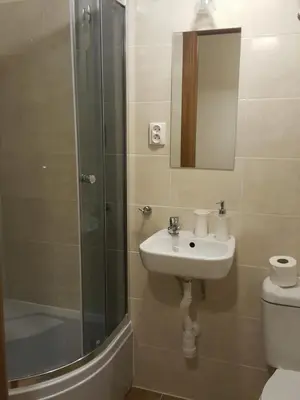 a bathroom with a sink and a shower and a toilet at Pokoje Gościnne Centrum in Kraków