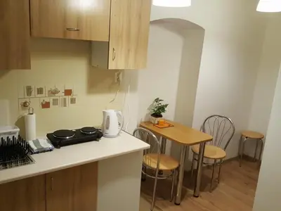 a small kitchen with a small table and chairs at Pokoje Gościnne Centrum in Kraków