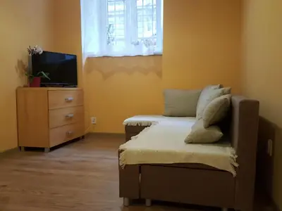 a bedroom with a bed and a tv and a dresser at Pokoje Gościnne Centrum in Kraków