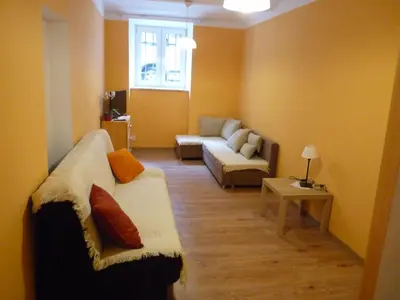 a living room with a couch and a table at Pokoje Gościnne Centrum in Kraków