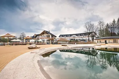 a pool of water in front of a resort at Hotel Molo Resort in Osiek