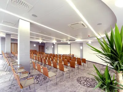 a conference room with chairs and a whiteboard at Hotel Molo Resort in Osiek