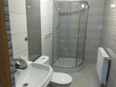 a bathroom with a shower and a toilet and a sink at Antares noclegi u Basi in Młoszowa