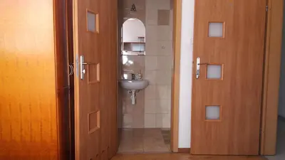 a bathroom with a sink and a door leading to a bathroom at Antares noclegi u Basi in Młoszowa