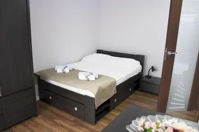 a bedroom with a bed with two towels on it at Apartament Wilga Park in Kraków
