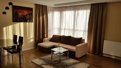 a living room with a couch and a table at Apartament Wilga Park in Kraków