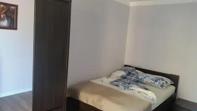 a small bedroom with a bed and a mirror at Apartament Wilga Park in Kraków