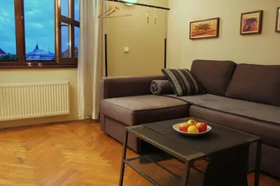 a living room with a couch and a bowl of fruit on a table at 4Party in Kraków
