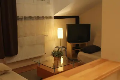 a living room with a couch and a tv at 4Party in Kraków